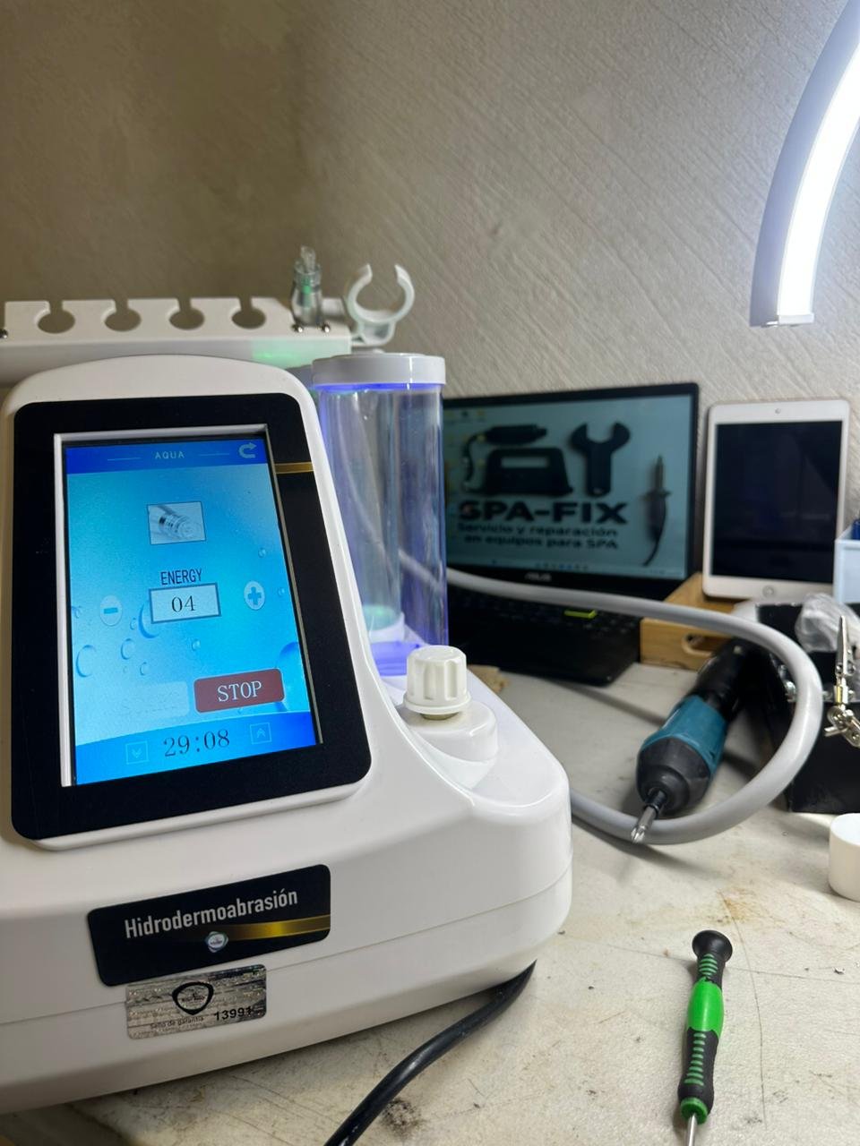 Hydrodermabrasion medical device with touchscreen display in a clinic setting alongside other equipment